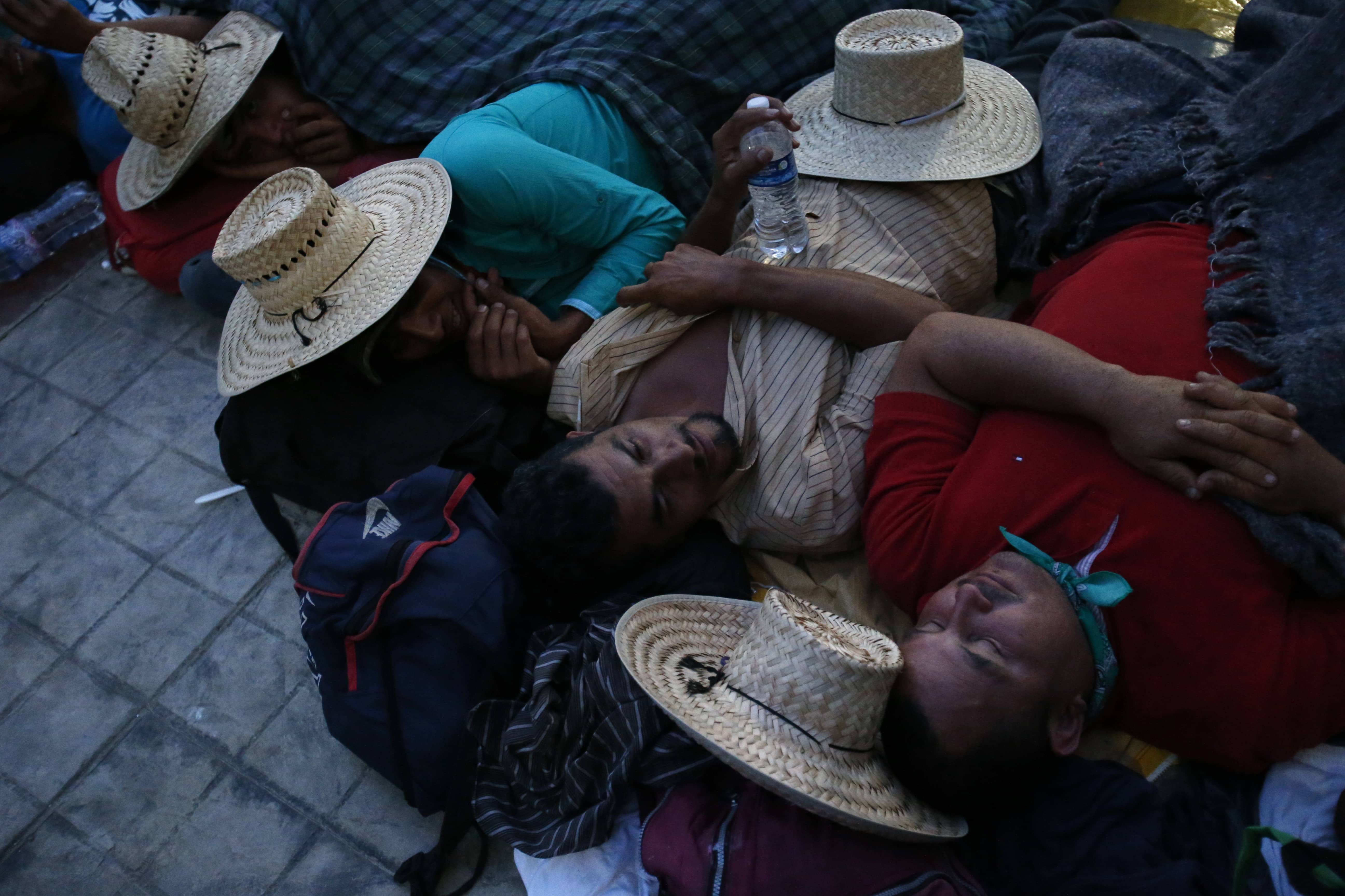 Photo of migrants sleeping in a church courtyard at nightfall 